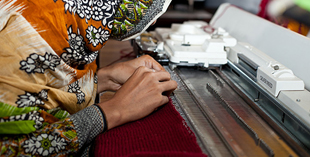 Woman working on a sewing machine during a training session